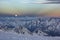 Snowy Caucasus mountains at sunset with moonrising and Anticrepuscular rays