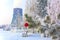 Snowy Christmas tree decorated with toys. Against the background of industrial objects