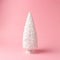 Snowy Christmas tree on pastel pink background. Christmas or New Year minimal concept