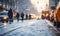Snowy city scene with blurred traffic and pedestrians on crosswalk, winter morning with glowing sunlight and snowflakes in urban
