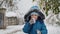 In a snowy city, a strong child battles the blizzard, shoveling a path through the difficult winter weather