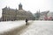 Snowy damsquare with the Royal Palace in Amsterdam