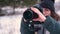 On a snowy day, a girl photographer takes pictures of the winter forest