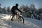 Snowy descent with a mountain bike. Snow downhill with bike, mtb action in winter, with deep snow and sun as a backlight