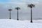 Snowy embankment along the misty river with lanterns at the foggy morning - winter landscape. II