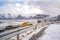 Snowy empty road along the sea & shoreline & beach in Lofoten.