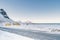 Snowy empty road along the sea & shoreline in the white cold world of north Norwegian islands.