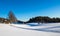 Snowy farm landscape with ski tracks