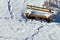 Snowy foot prints around snow covered park bench