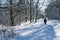 Snowy footpath with a walking woman