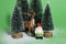 Snowy forest firs gnome and reindeer green