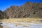 Snowy grass field at the entrance of the Yolyn Am or Yoliin Am canyon in spring, Gobi Gurvansaikhan National Park. Mongolia