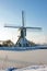 Snowy historical windmill in the countryside from Netherland