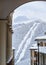 Snowy hotel roofs of Gorky Gorod winter mountain ski resort on snowy ski slope and ski lift background. Beautiful scenic landscape
