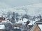 Snowy houses with mountains in the background