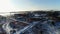 Snowy land with bare trees near waste water treatment plant