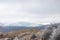 Snowy Landscape of Bulgarian mountains. Communist monument Buzludzha in the back