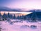 Snowy landscape on a mounatin range with spruce trees covered with snow and rime shortly before sunset