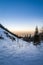 Snowy landscape in mountains. Golden hour sunset