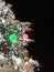 Snowy lighted Christmas tree with glowing bulbs