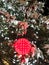 Snowy lighted Christmas tree with glowing red bulbs