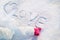 Snowy Love: Young Girl\\\'s Finger Drawing Heart Shape and \\\'Love\\\' in the Snow