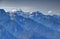 Snowy Mangart peak and forested ridges in Julian Alps, Slovenia