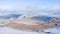 Snowy meadow with forest strips and empty agrarian fields. Winter landscape.