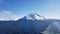 Snowy mountain islands on a blue spring day in the arctic circle as seen from a big ship sailing to Finnmark