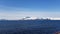 Snowy mountain islands on a blue spring day in the arctic circle as seen from a big ship sailing to Finnmark
