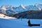 Snowy mountain landscape with barns and railroad line