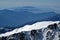 Snowy mountain lansdscape with mountain layers, ocean view in the background, Corsica, France