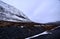 Snowy mountain next to the road with cloudy sky about to snow in very cold