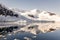 Snowy mountain peak and the glacier reflected in the Antarctic waters of Neco bay