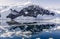 Snowy mountain peak and the glacier reflected in the Antarctic waters of Neco bay