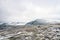 Snowy mountain peaks in Rondane national park in Norway. Snowy, foggy and frozen landscape during winter.