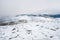 Snowy mountain peaks in Rondane national park in Norway. Snowy, foggy and frozen landscape during winter.