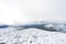 Snowy mountain peaks in Rondane national park in Norway. Snowy, foggy and frozen landscape during winter
