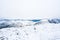 Snowy mountain peaks in Rondane national park in Norway. Snowy, foggy and frozen landscape during winter.