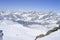 Snowy mountain range running down into the valley in Swiss Alps