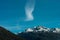 Snowy mountain summit with strange cloud formation