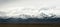 Snowy mountains in clouds in Tibet panorama view