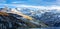 Snowy mountains in northern french Alps. with a lake. with a blue sky and clouds