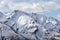 Snowy mountains and sky with clouds