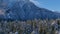 Snowy Mountains and Trees in Canadian Nature Landscape. Winter Season, Sunny Day. Aerial View