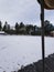 Snowy parking lot beside a cemetery