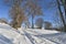 Snowy path crossing  the alpine mountain