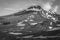 Snowy peak of the Koryak hill on a Sunny day in summer. Camel mountain at the foot of the volcano