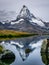 The snowy peak of the Matterhorn in Switzerland is reflected in the surface of a mountain lake