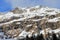Snowy peak of rocky mountains. High alpine massif